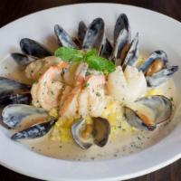 Seafood Risotto · King shrimp, sea scallops, and mussels served over creamy demi glaze and roasted garlic mash...