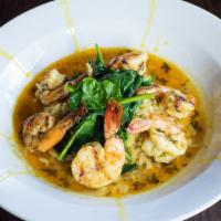 Grilled King Shrimp · Served with orzo pasta, currants, and raisins. Tossed in an Indonesian curry sauce topped wi...