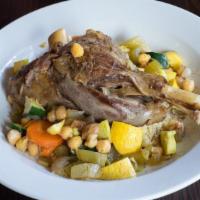 Braised Lamb Shank Tangine · Served with sun-dried cranberry couscous, winter vegetables in apple cider honey saffron bro...
