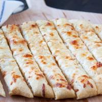 Cheesy Bread Sticks · Cheesy garlic butter bread sticks served with tomato dipping sauce.