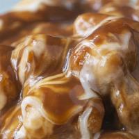 Poutine Tater Tots · Tater tots lightly salted, fried golden brown, and topped with gravy & cheese!
