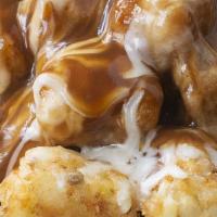Gravy Tots · Tater tots lightly salted, fried, golden brown and topped with gravy.