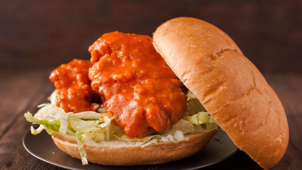 Buffalo Chicken Sandwich · Crispy chicken breast drizzled with buffalo sauce on a soft sandwich roll with a side of creamy coleslaw and bag of chips.