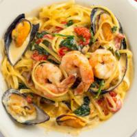 Seafood Florence · Shrimp, clams, mussels, sauteed mushrooms, roasted red peppers and spinach served over lingu...