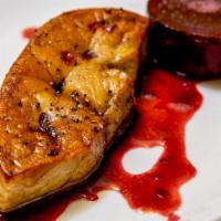 Foie Gras De Canard Poelle · Seared duck foie gras served with seasonal aspic port wine reduction.