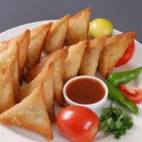Aloo Samosa (2 Pieces) · Handmade pastry stuffed with seasoned potato and peas. Served with green and red chutneys.