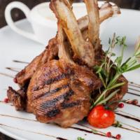 Lamb Chops (4 Pieces) · Marinated and cooked in spicy in house blend. Served with chutney and house salad.