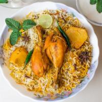 Chicken Biryani · Seasoned chicken pieces cooked in a traditional oven, sautéed in spices, layered in long gra...