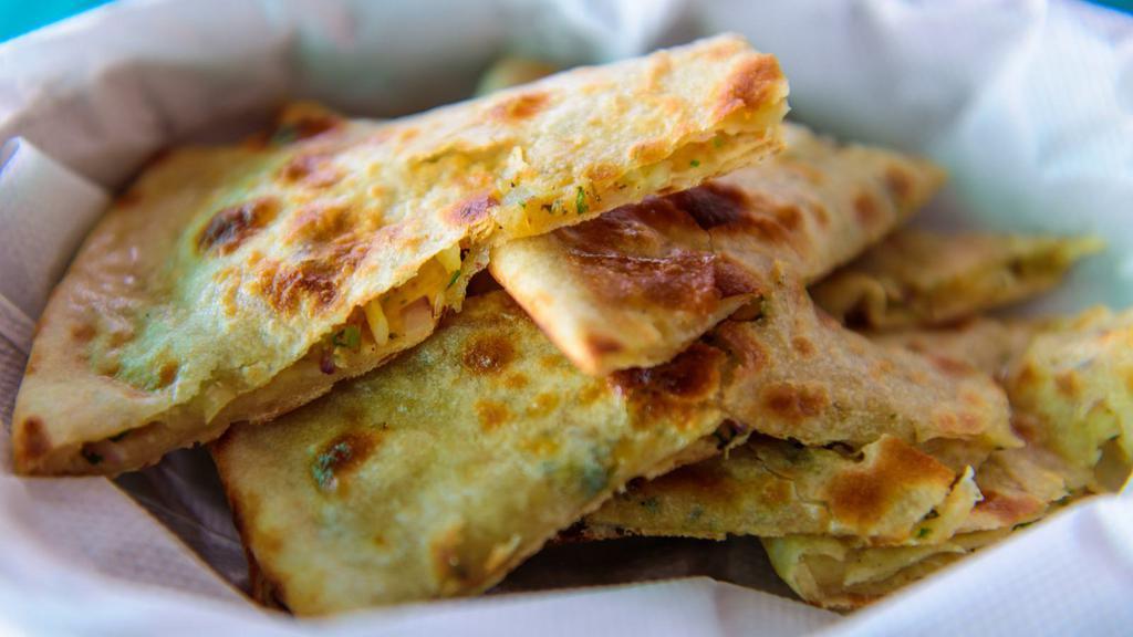 Onion Stuffed Naan · Traditional Indian Flatbread stuffed with finely chopped seasoned red onion.