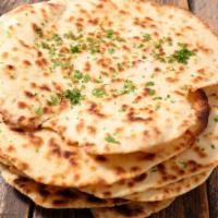 Butter Naan · Indian flatbread made from white mix flour and cooked in traditional tandoor oven topped wit...