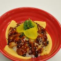 Unagi Don · Eight pieces of roasted eel placed over white rice.