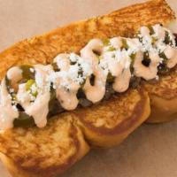 Old Town · smoked bacon dog, caramelized onions, pickled jalapeños, chipotle aioli, cotija cheese.