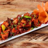 Chili Paneer  · Cottage cheese sautéed with soy, onions, green chilies, herbs and exotic spices.