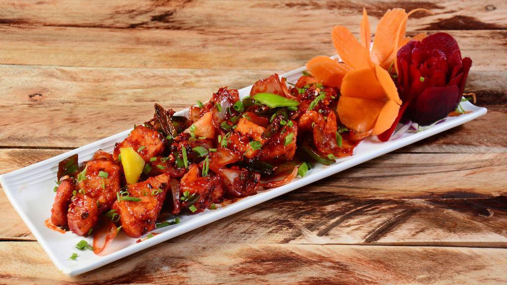 Chili Paneer  · Cottage cheese sautéed with soy, onions, green chilies, herbs and exotic spices.