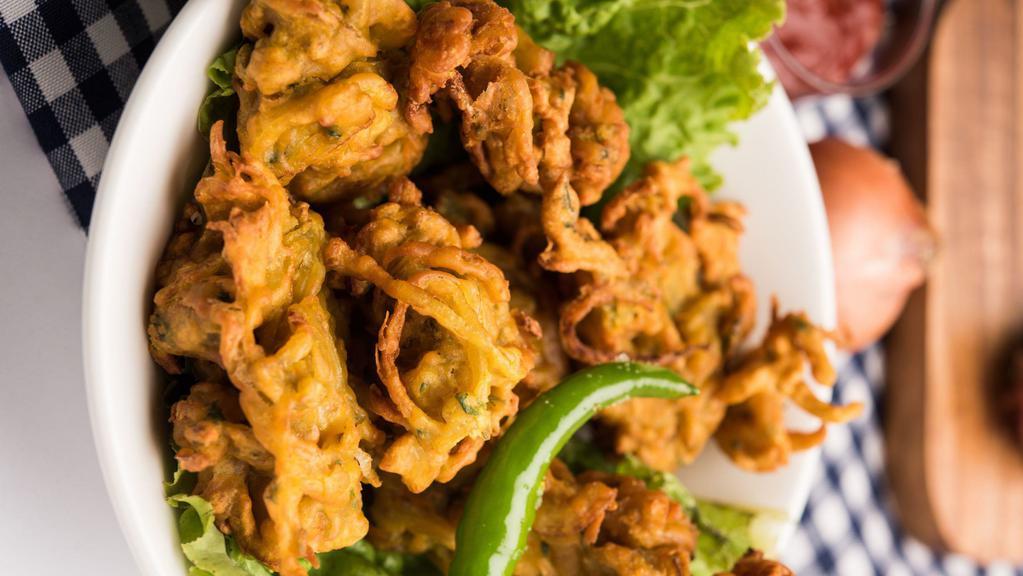 Onion Pakora · Freshly sliced onions dipped in chickpea batter and deep fried to golden crisp.