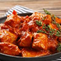 Chicken Vindaloo · Boneless chicken cooked in a tangy tomato sauce with potatoes and spicy chilies.