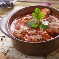 Lamb Rogan Josh · Aromatic lamb curry in a ginger infused onion and tomato sauce with coriander leaves.