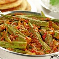 Bhindi Masala · Masala coated okra cooked on a low flame with diced onions and tomatoes.