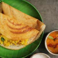 Masala Dosa · Thin rice and lentil crêpe filled with deliciously spiced onions and potatoes.