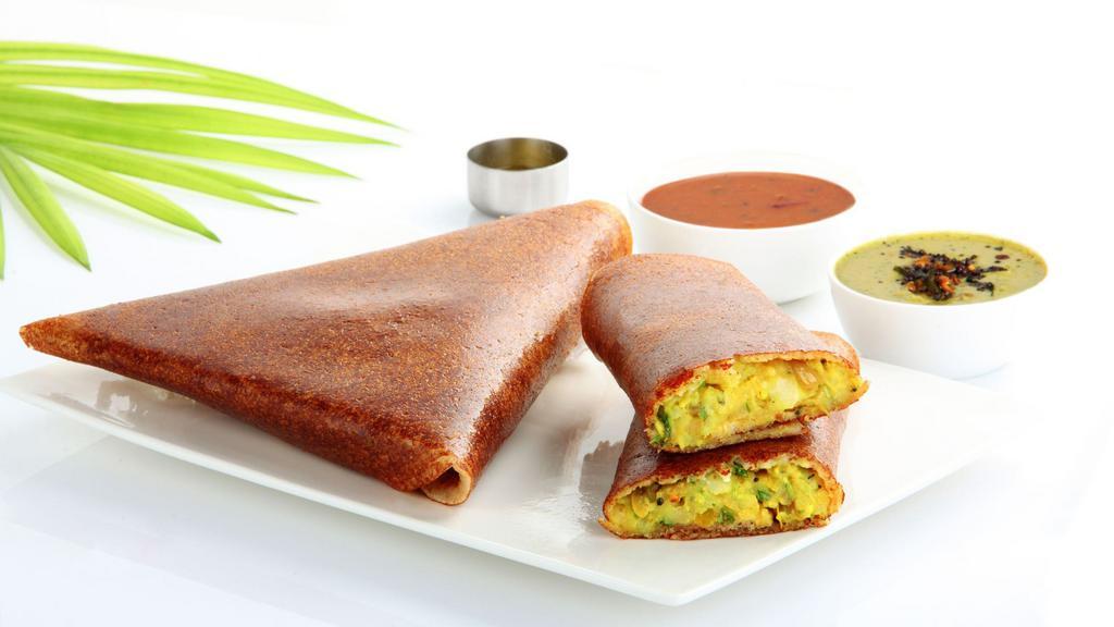 Mysore Masala Dosa · Thin rice and lentil crêpe filled with deliciously spiced onions and potatoes and a layer of spicy Mysore chutney.