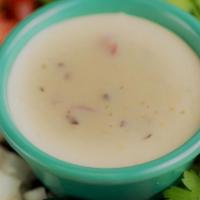 Queso Dip** · Smooth and creamy cheese dip blended with roasted chiles and tomato.