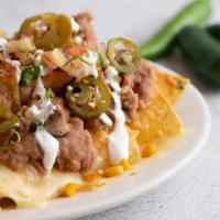 Nachos** · Corn tortilla chips w/ extra melted cheese, choice of meat, refried beans, pico de gallo, sw...