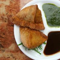 Meat Samosa (Each) · Triangular pies stuffed with ground chicken, herbs and spices.