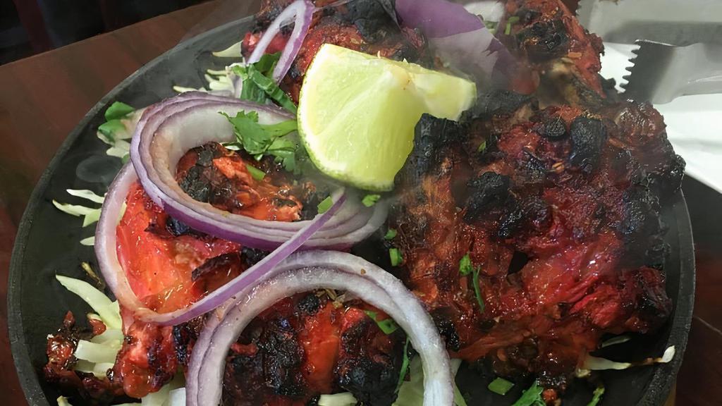 Tandoori Chicken (5 Pcs) · On sizzler. One half chicken marinated overnight in yogurt and spices and barbecued in a traditional clay oven.