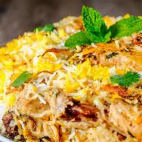 Chicken Biryani · Spiced cooked chicken with saffron flavor basmati rice with traditional spices.