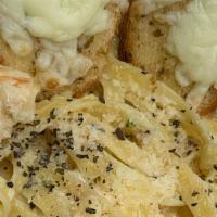 Fettuccine Shrimp · Fettuccine shrimp served with Alfredo sauce,  Parmesan cheese and 2 pieces of garlic bread
