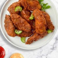 Hot Shot Wings · Crispy wings fried until golden brown, and tossed in hot sauce. Served with your choice of d...
