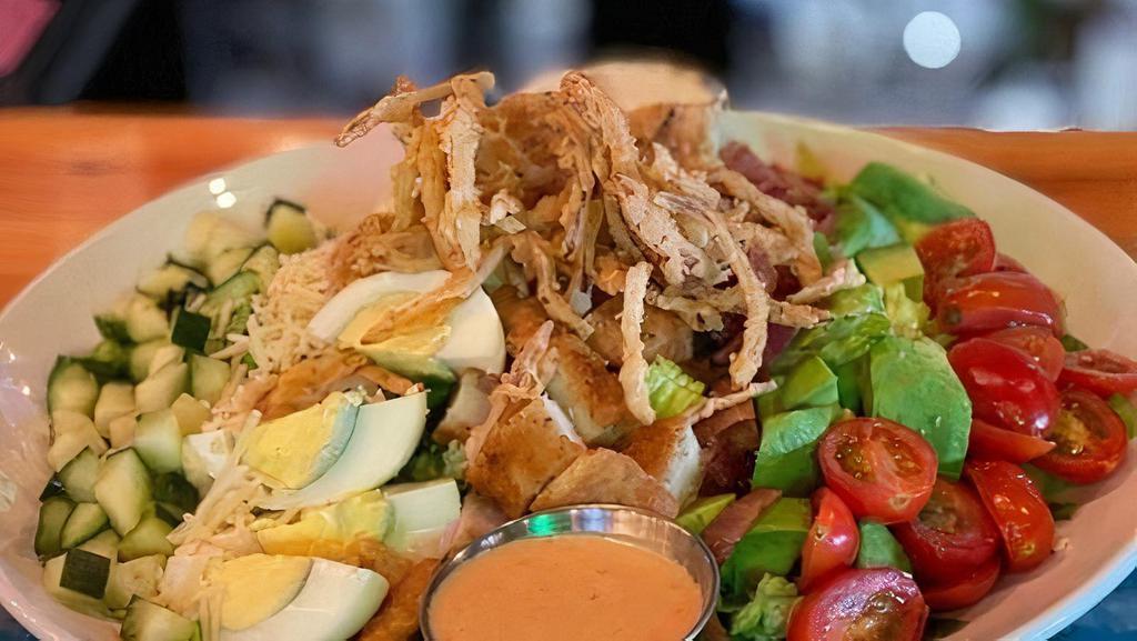 Cobb Salad · Romaine, avocado, hardboiled egg, grape tomatoes, cucumbers, bacon, parmesan cheese, chives,  fried onions, buffalo blue cheese dressing