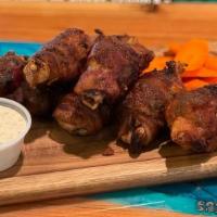 Bourbon Bacon Wings · Bacon-wrapped chicken wings brushed with bourbon glaze, celery, carrots and ranch.