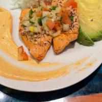 Salmon Bake · Baked salmon, avocado, mango pico de gallo and spicy mayo over steamed rice topped with gree...