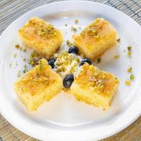 Naamoura · Semolina squares baked until golden, with a drizzle of sugar water topped with an almond
