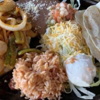 Chicken Fajita · Served with Hot Flour Tortillas, Sauteéd Onions and Peppers Mexican Rice, Refried Beans, Che...
