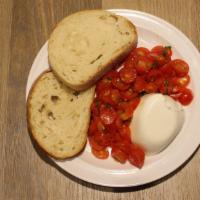 Caprese Salad* · Buffalo mozzarella, cherry tomatoes, garlic, olive oil served with bread. *
