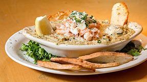 Alaskan Crab & Spinach Dip · Rich crab and spinach in a creamy garlic mixture served with warm toasted ciabatta bread.