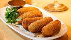 Pioneer Poppers · Fresh beer battered jalapeños stuffed with our special cheese and bacon blend. Served with o...