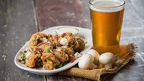 Mt Mckinley Mushrooms · Fresh mushrooms beer-battered, topped with bacon bits, blue cheese and green onions, served ...