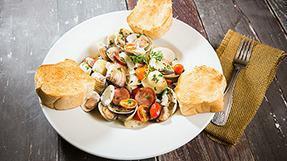 Knik Steamer Clams · Sautéed in our special herb wine and garlic butter sauce served with a baguette bread slice ...