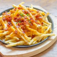 Monster Fries · Golden fries with cheese wiz, crispy bacon, ranch, onions, and jalapeños.