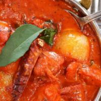 Kadai Chicken · Chicken, bell peppers, onion, and tomatoes in kadai (skillet) with traditional spices and he...