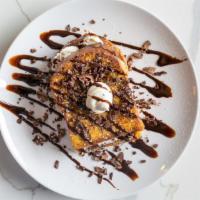 Stuffed Cannoli French Toast · Stuffed with cannoli cream and topped with chocolate chips drizzled with chocolate syrup