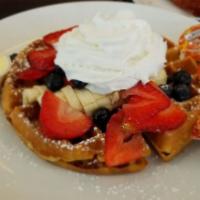 Waffle Deluxe · Topped with fresh strawberries, blueberries, banana and whipped cream
