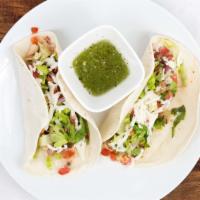 Tacos · Two tacos with choice of protein, style* and side of corn tortilla chips.  
Choice of Style:...
