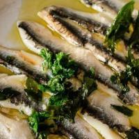 White Anchovies* · Marinated white anchovies with olive oil and fried parsley