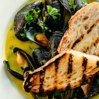 Mussels* · wild garlic, pickled Hungarian chilis, cilantro, fett’unta