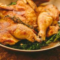 Chicken Under A Brick* · Half a partially-deboned chicken is seasoned with pesto, then seared with a weight on top fo...