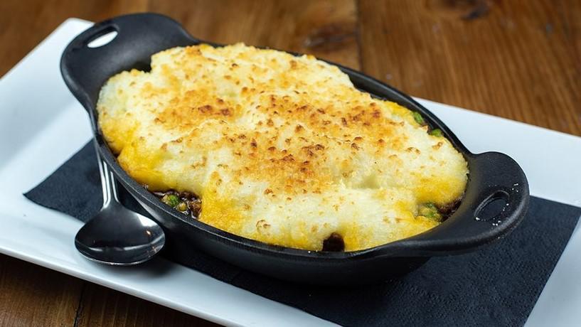 Shepherd'S Pie · Ground beef, carrots, peas, onions and herbs in a rich brown gravy, topped with creamy potatoes and parmesan cheese served with Irish soda bread.